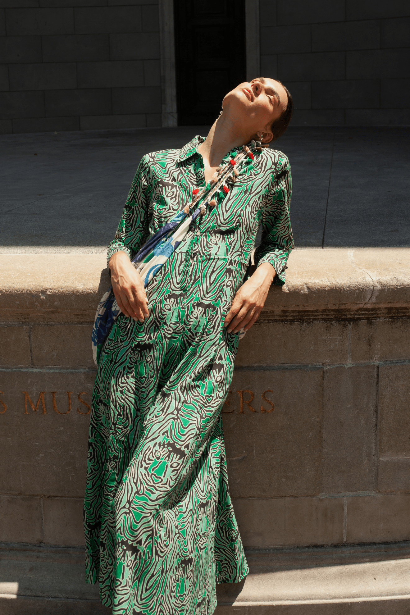 Model wearing a white embroidered bohemian dress from Guadalupe Design.