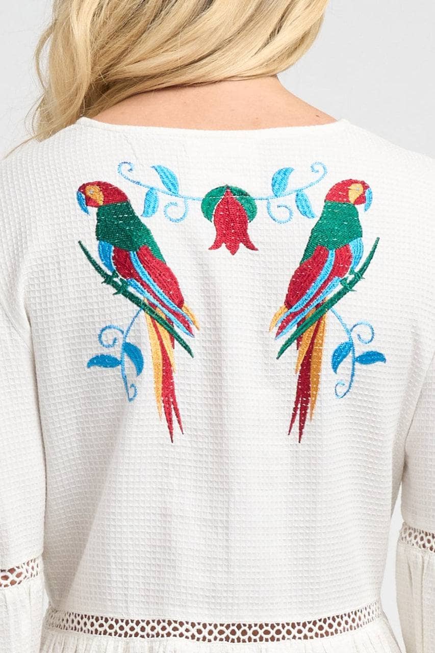 Sofia Parrot Dress, showcasing its vibrant parrot print.